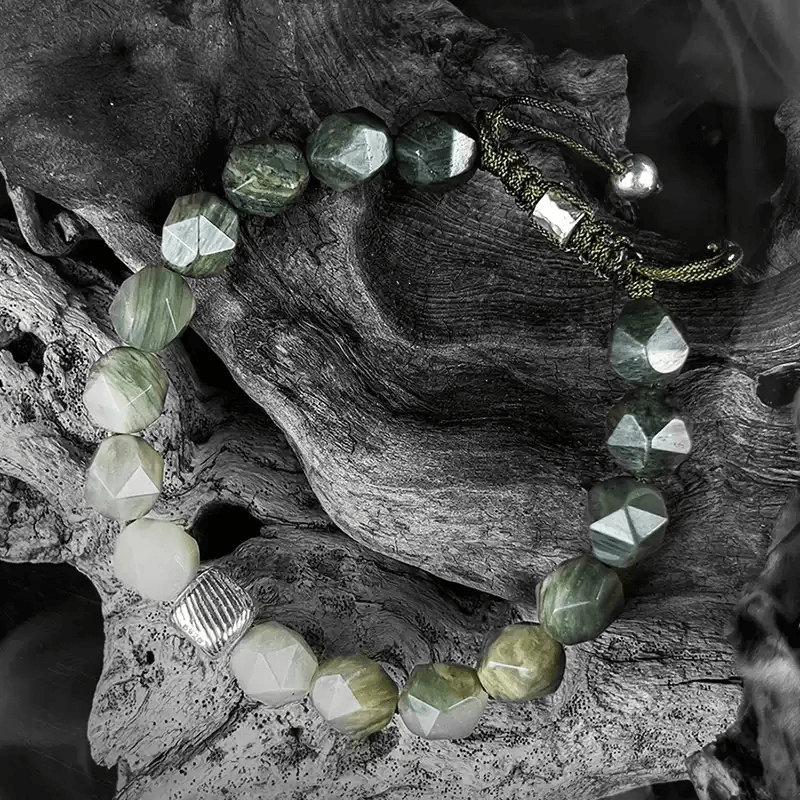 Close-up of 8mm Green Amphibole’s faceted cut for Throat Chakra clear communication and self-expression