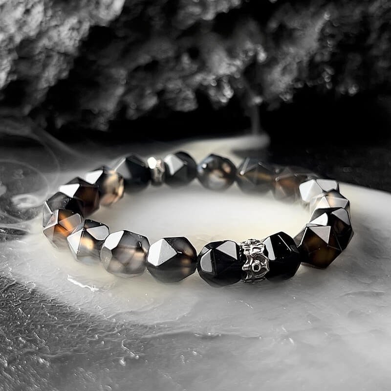 Close-up of Black Agate beads with dark-to-light gradient texture, symbolizing transformation and inner strength