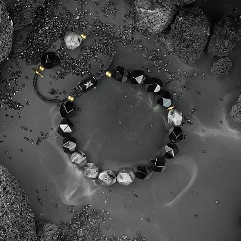 Close-up of Black Agate’s smooth matte surface for Root Chakra security and negative energy absorption