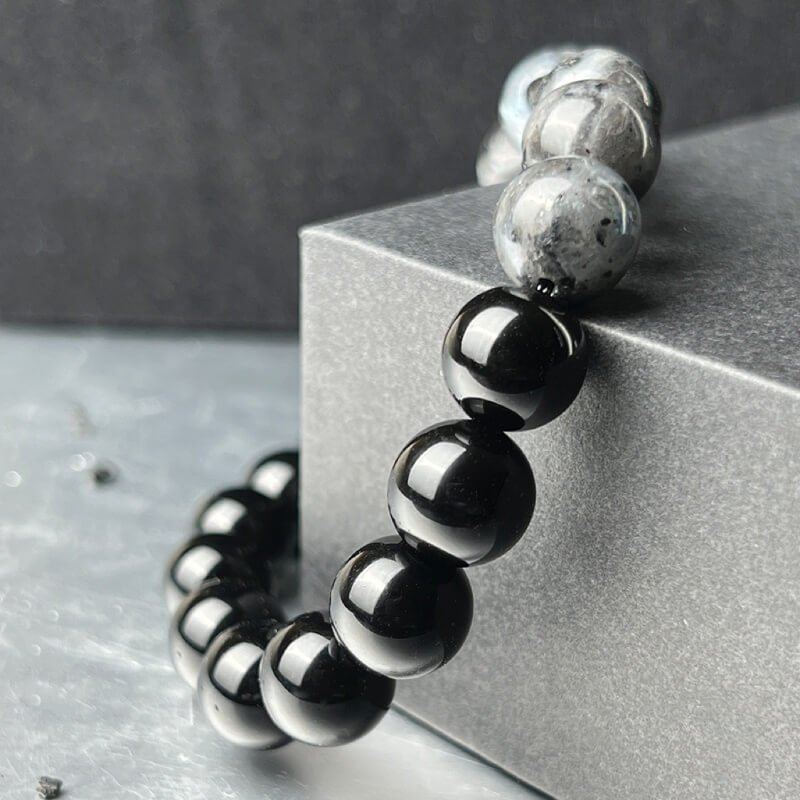 Close-up of Black Agate’s smooth matte surface for Root Chakra foundation and negative energy absorption