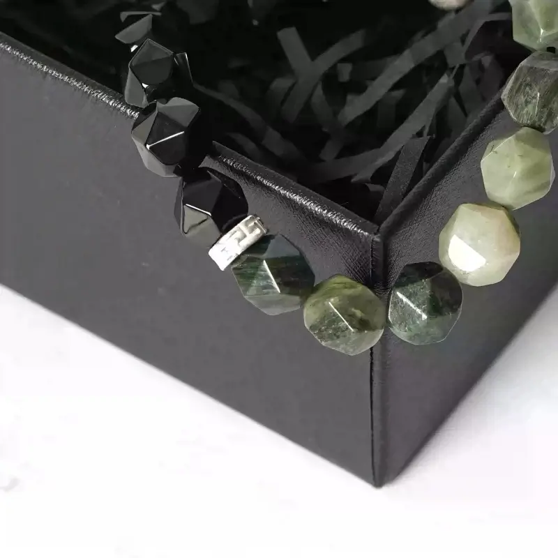 Close-up of Black Agate’s smooth matte surface and Thai Silver floral engraving for Root Chakra stability and energy purification