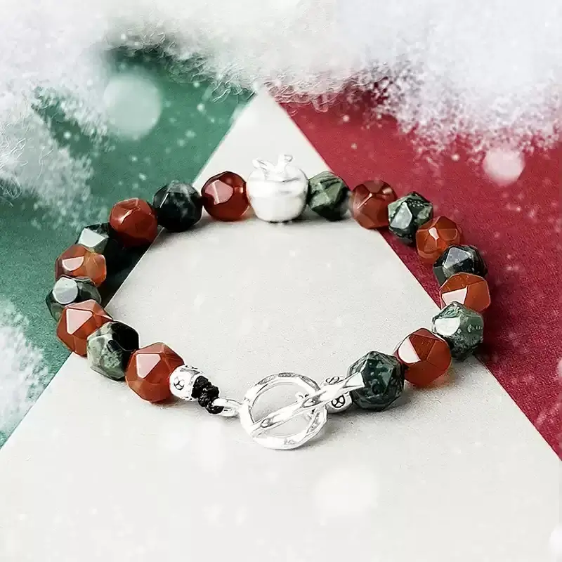Woman wearing red agate bracelet at Christmas party for Heart Chakra harmony and festive energy protection