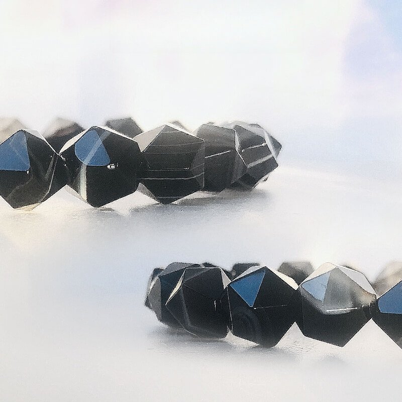 Close-up of Black Agate and dark-toned agate synergy for enhanced Root Chakra grounding and emotional resilience