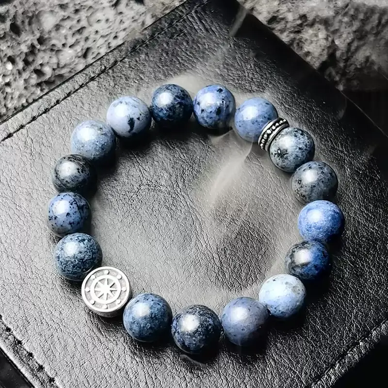 Close-up of 10mm Dumortierite beads with deep blue veined texture – symbolizes wisdom, creativity, and Throat Chakra activation.