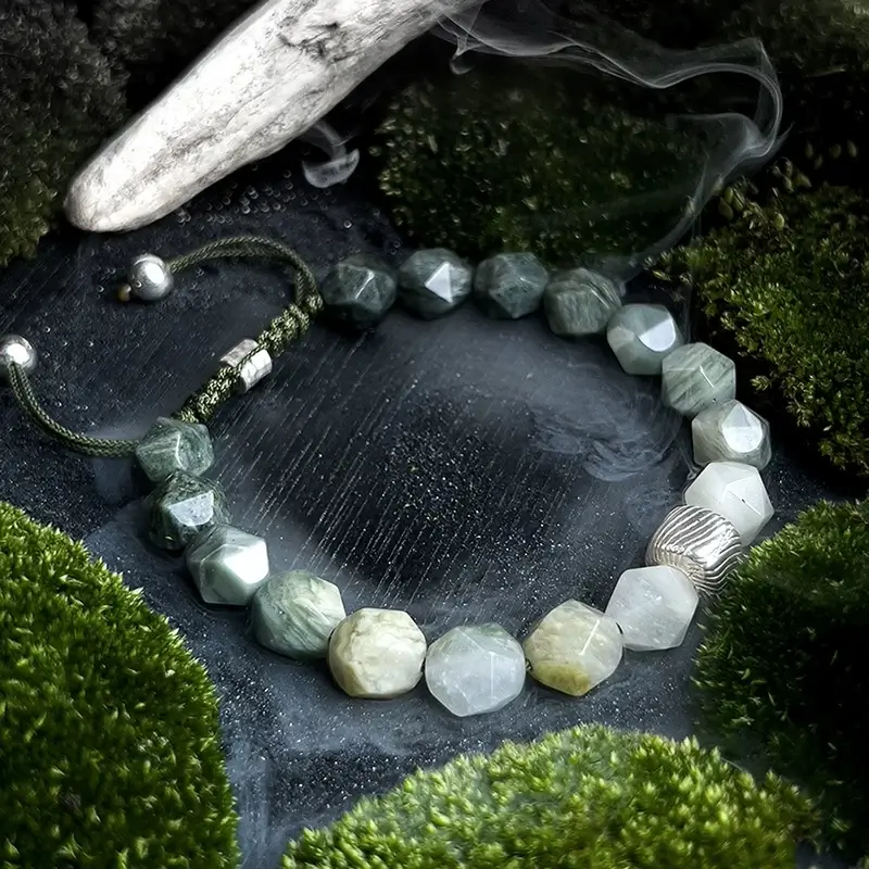 Woman wearing Green Amphibole bracelet for Heart Chakra calm and Throat Chakra clarity during outdoor adventures
