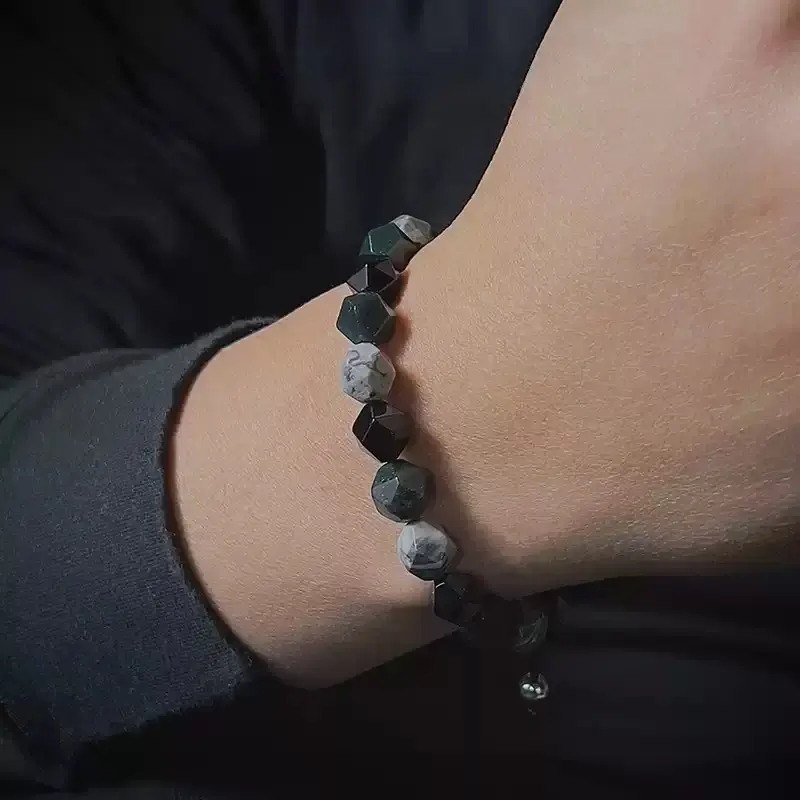Woman wearing Quezai Stone bracelet in forest for Heart Chakra calm and natural energy