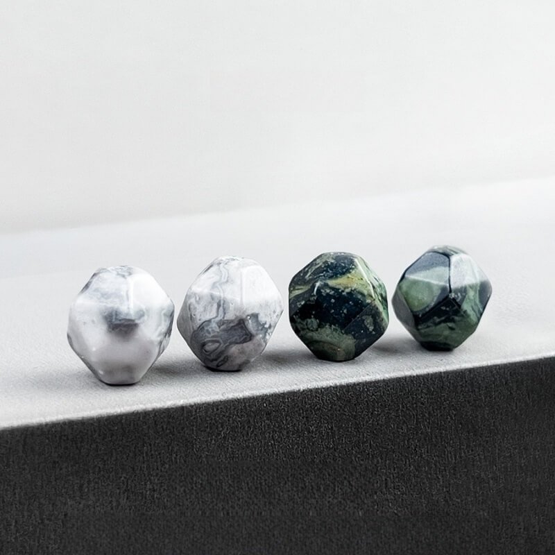 Close-up of 10mm finchite (green) and Picasso stone beads – natural textures symbolizing forest vitality and creative imagination