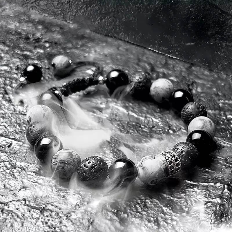 Obsidian, Picasso, and Volcanic Stone bracelet aligned with four chakras – balances Root (protection), Sacral (creativity), Solar Plexus (confidence), and Third-eye (insight).