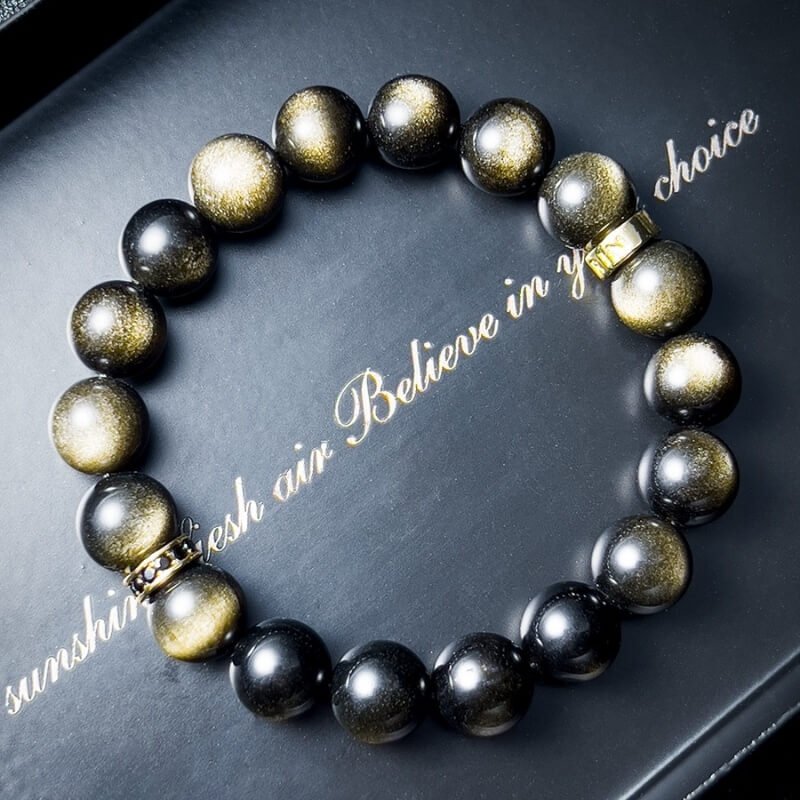 Close-up of Gold Sheen Obsidian’s natural golden sand texture for Root Chakra grounding and confidence enhancement