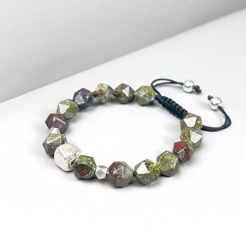Man wearing Dragon Blood Stone bracelet for courage and energy balance during outdoor adventures