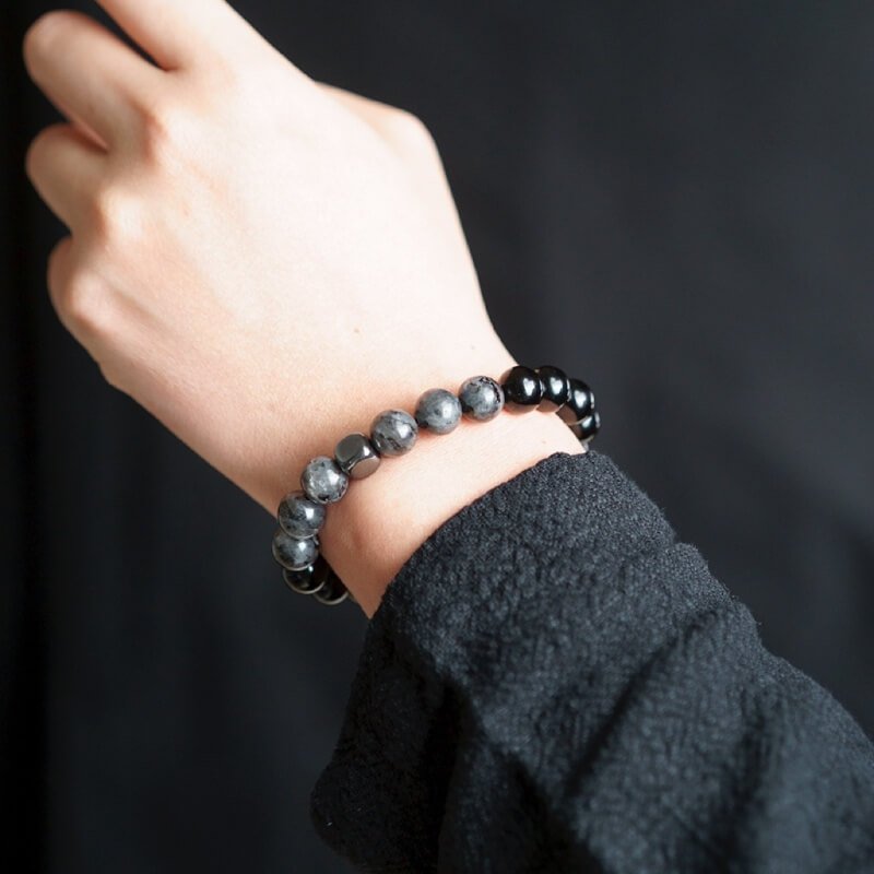 Man in business suit wearing Black Amphibole bracelet for Solar Plexus confidence and Root Chakra protection in high-stress roles