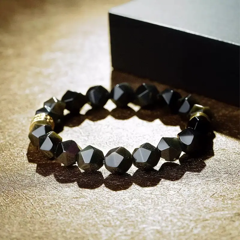 Close-up of Obsidian’s smooth matte surface for Root Chakra stability and negative energy absorption