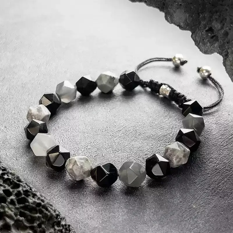 Person hiking with Map Stone bracelet for Heart Chakra exploration courage and Root Chakra grounding