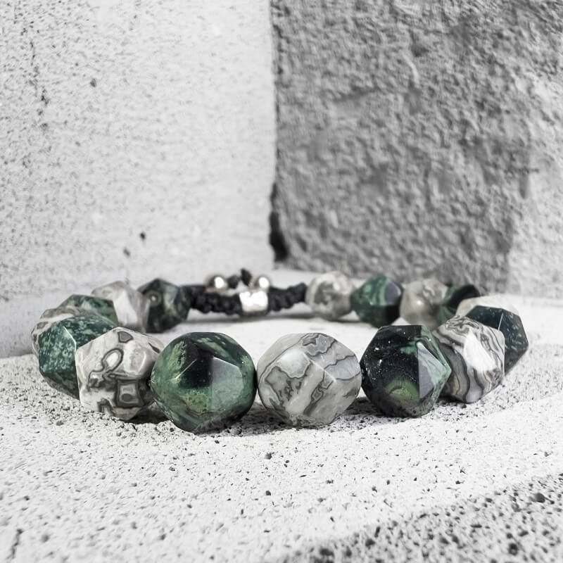Person hiking with Quezai and Map Stone bracelet for Heart Chakra calm and Throat Chakra focus in nature