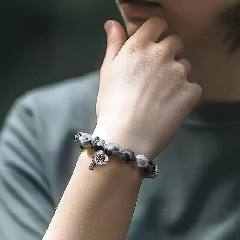 Person exploring nature wearing Emerald Odyssey bracelet for natural vitality and Solar Plexus inspiration