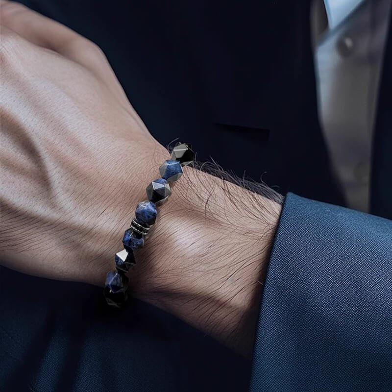 Man in business suit wearing Dumortierite bracelet for Throat Chakra confidence in client negotiations