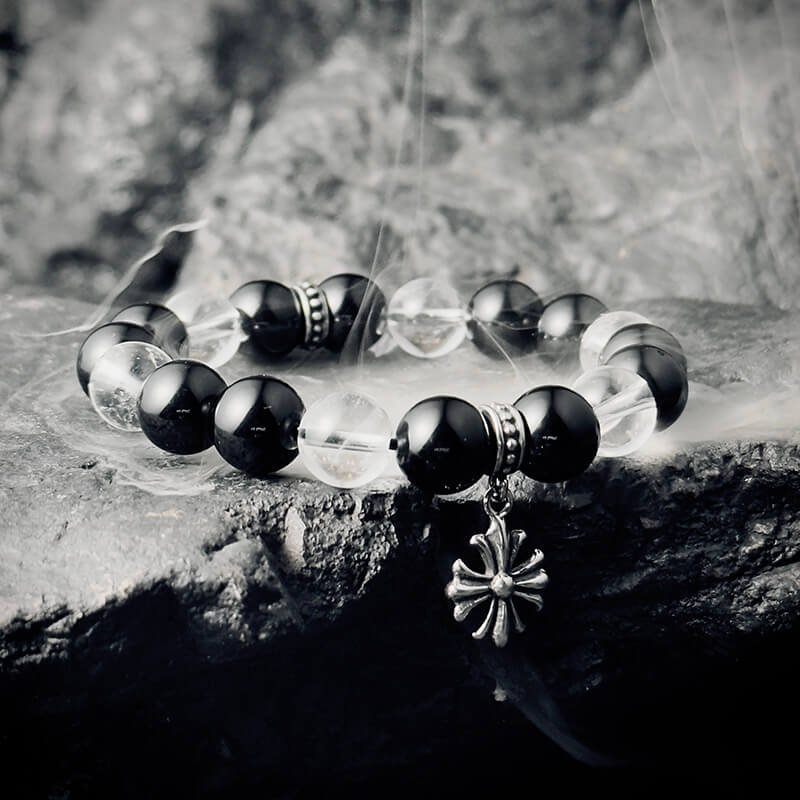 Detail of vintage metal star-moon accents enhancing White Crystal-Obsidian bracelet’s astrological charm