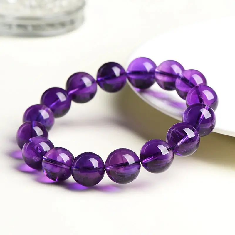 Close-up of 10mm genuine Uruguayan amethyst beads with deep purple night sky hues for emotional protection