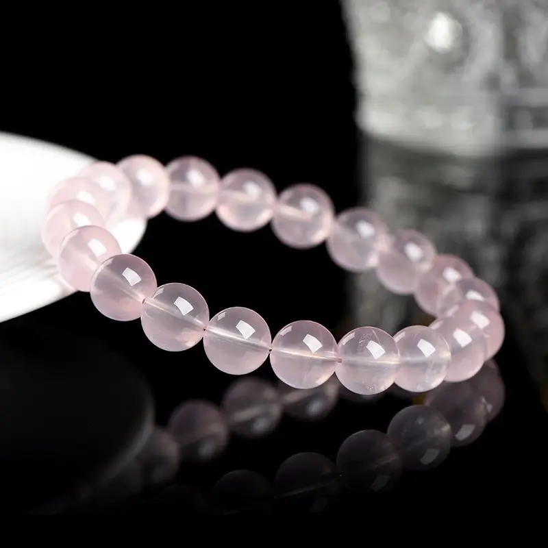 Close-up of 10mm natural Mozambique rose quartz beads with soft pink heart chakra energy