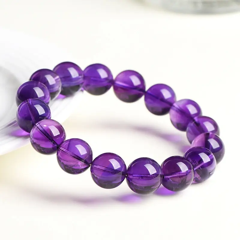 Model meditating with Uruguayan amethyst bracelet for stress relief and chakra balance